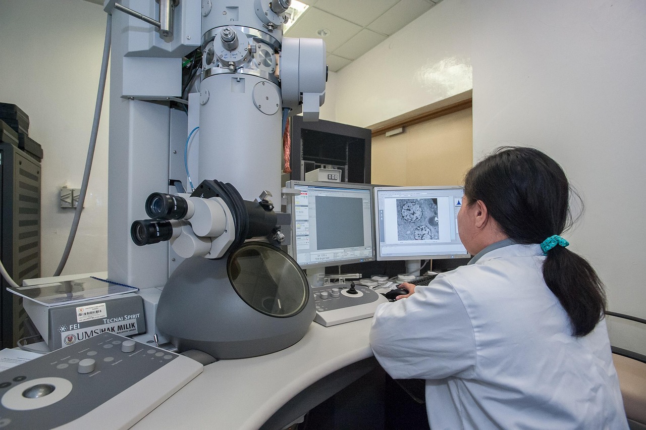 A microscope aimed at a glowing human silhouette