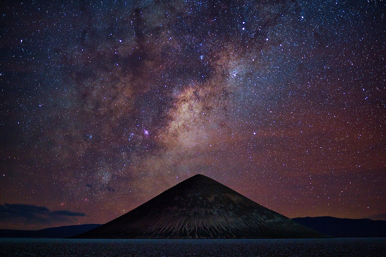 A dark mountain silhouette beneath the Milky Way